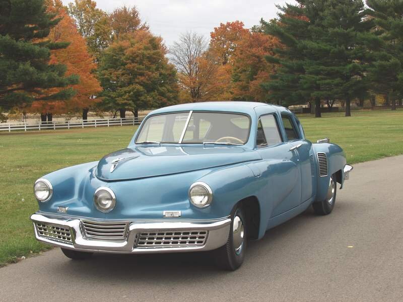 blue classic car on road