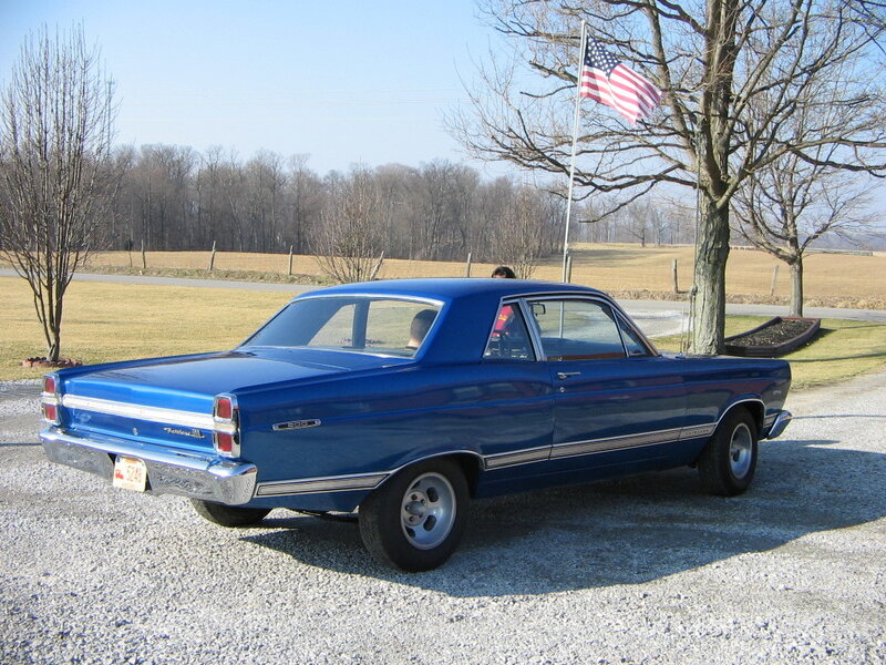 Blue classic car with American flag