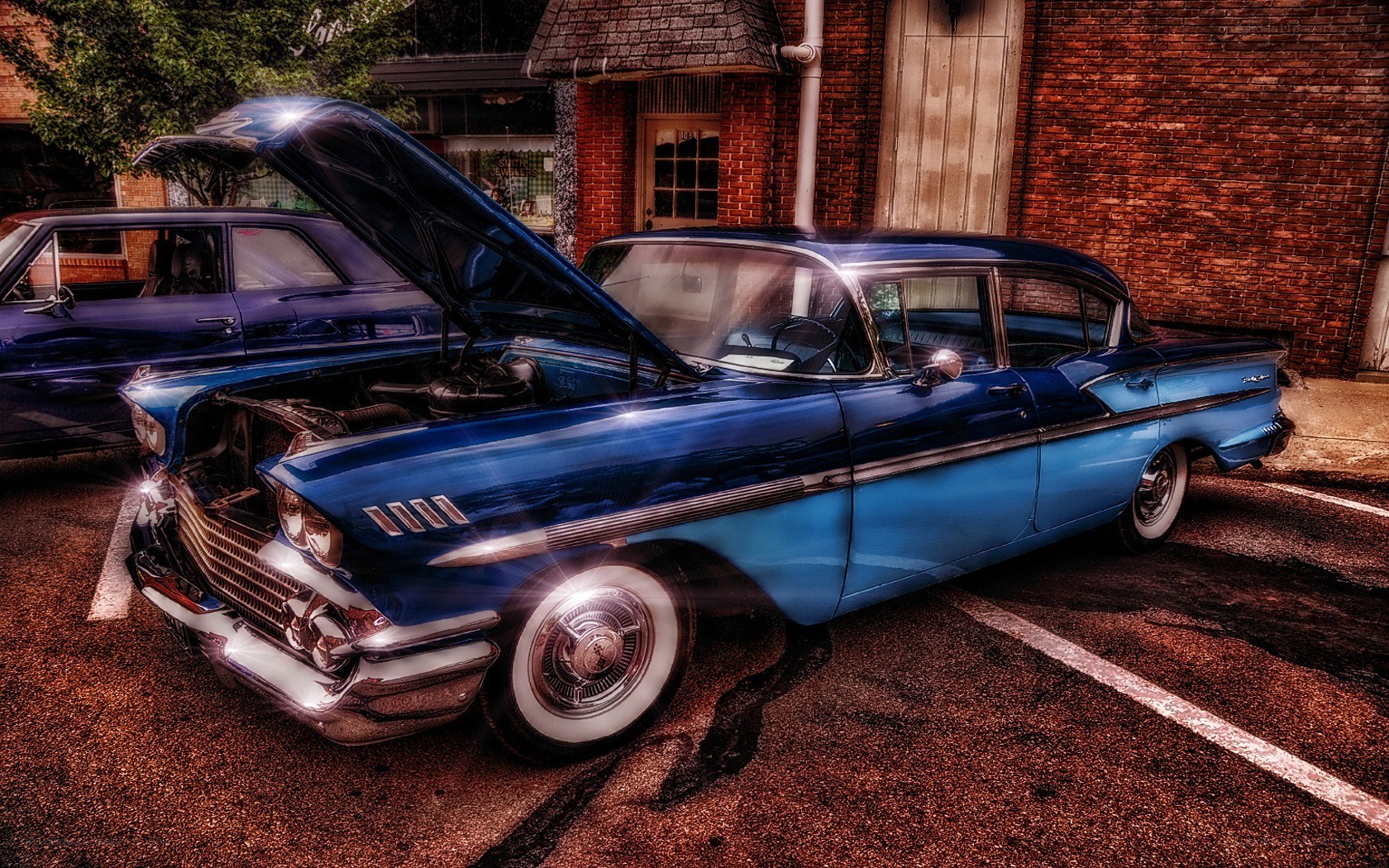 Blue classic car with open hood