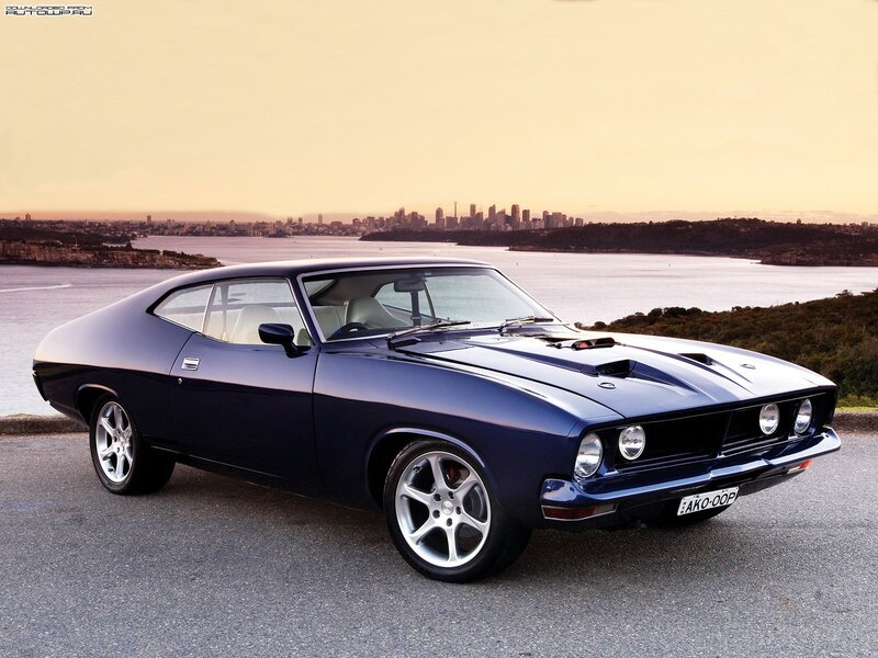 Blue classic muscle car by the water