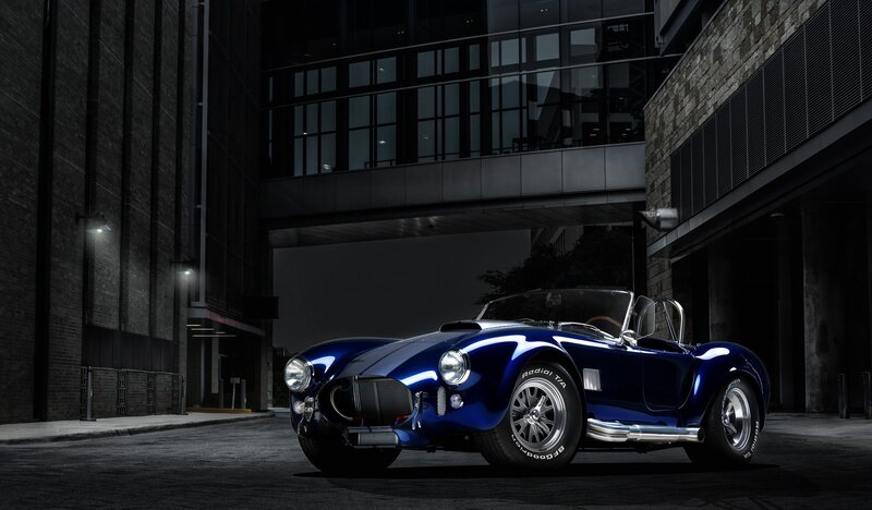 Blue classic sports car at night