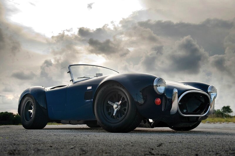 Blue classic sports car on asphalt