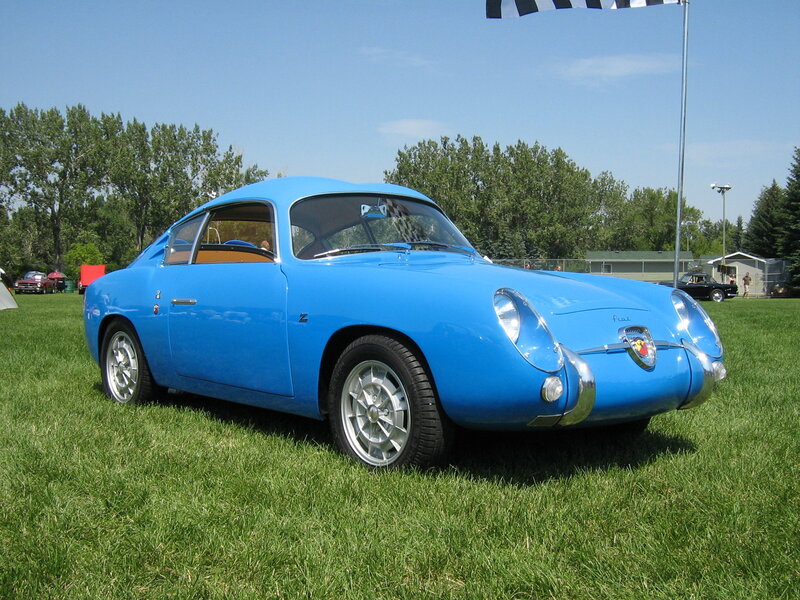 Blue classic sports car on grass