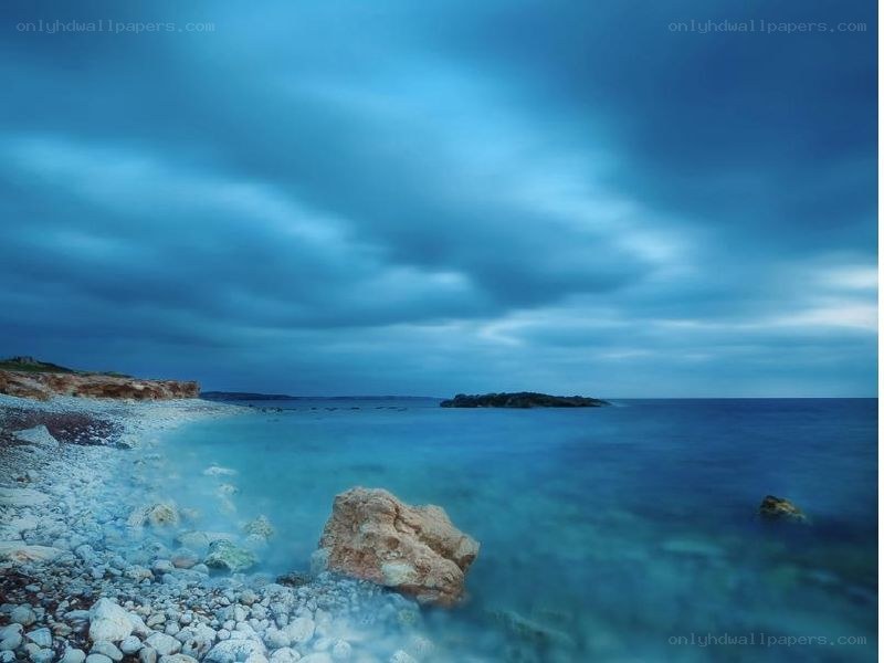 Blue coastal landscape at dusk