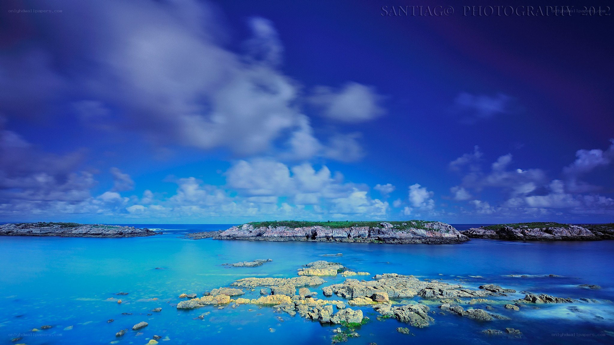 Blue coastal landscape with rocks
