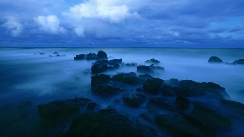 Blue coastal rocks at dusk
