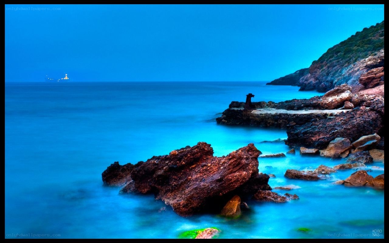 Blue coastal rocks at dusk