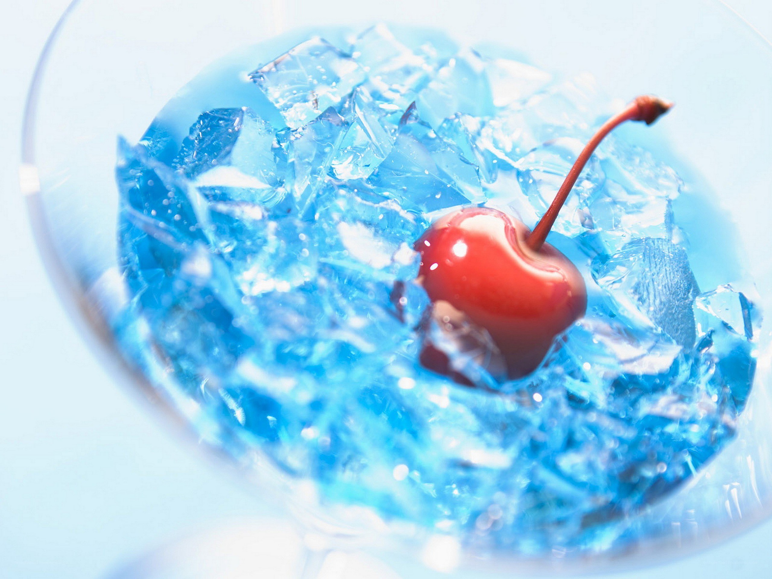 blue cocktail with cherry