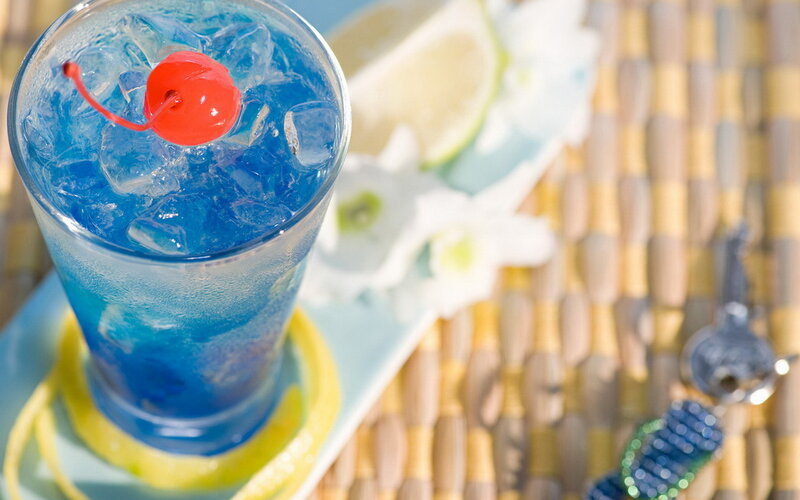 blue cocktail with cherry