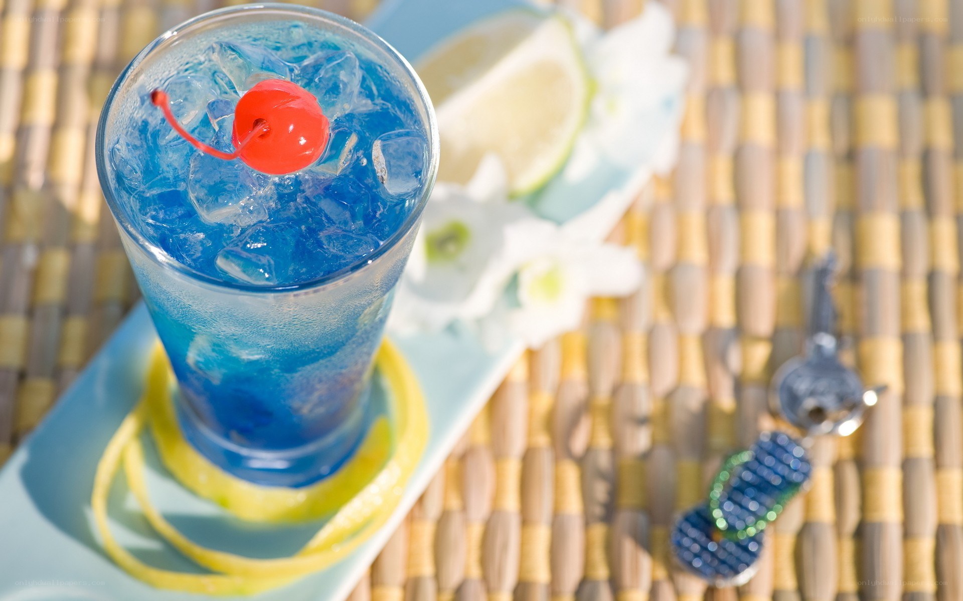 Blue cocktail with cherry garnish