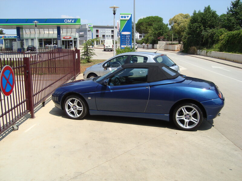 Blue convertible at gas station