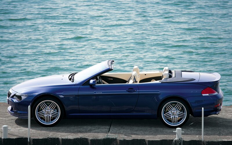 blue convertible by the water