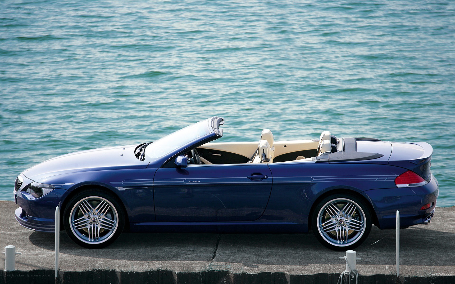 blue convertible by the water