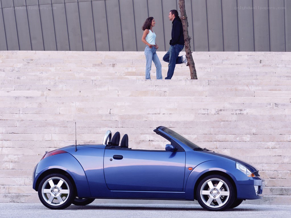 Blue convertible car with couple