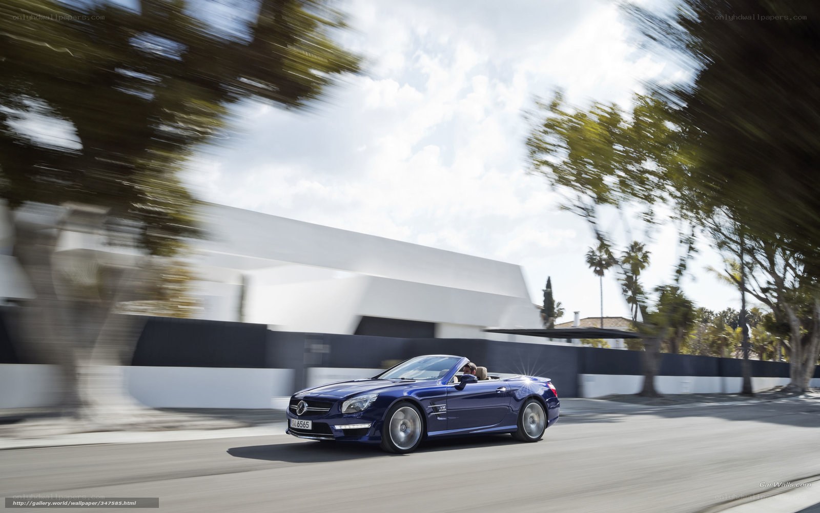 Blue convertible driving on road