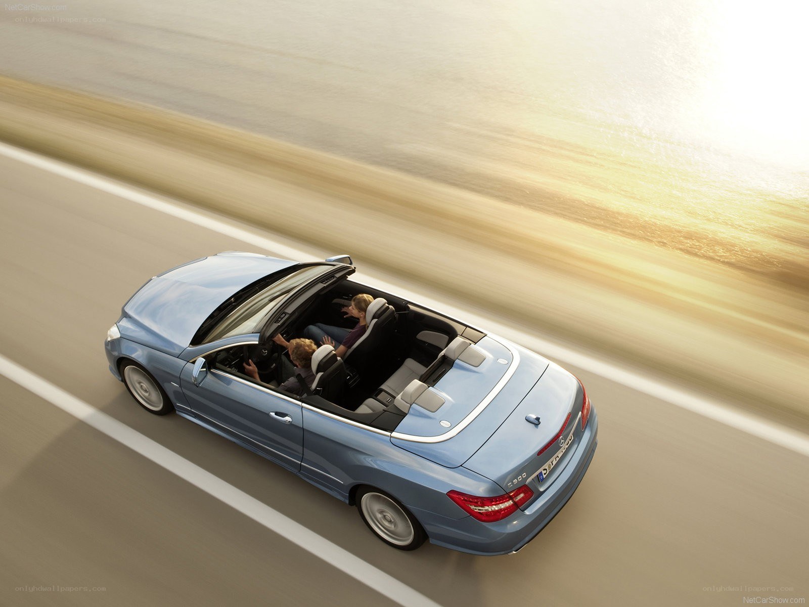 Blue convertible driving on road