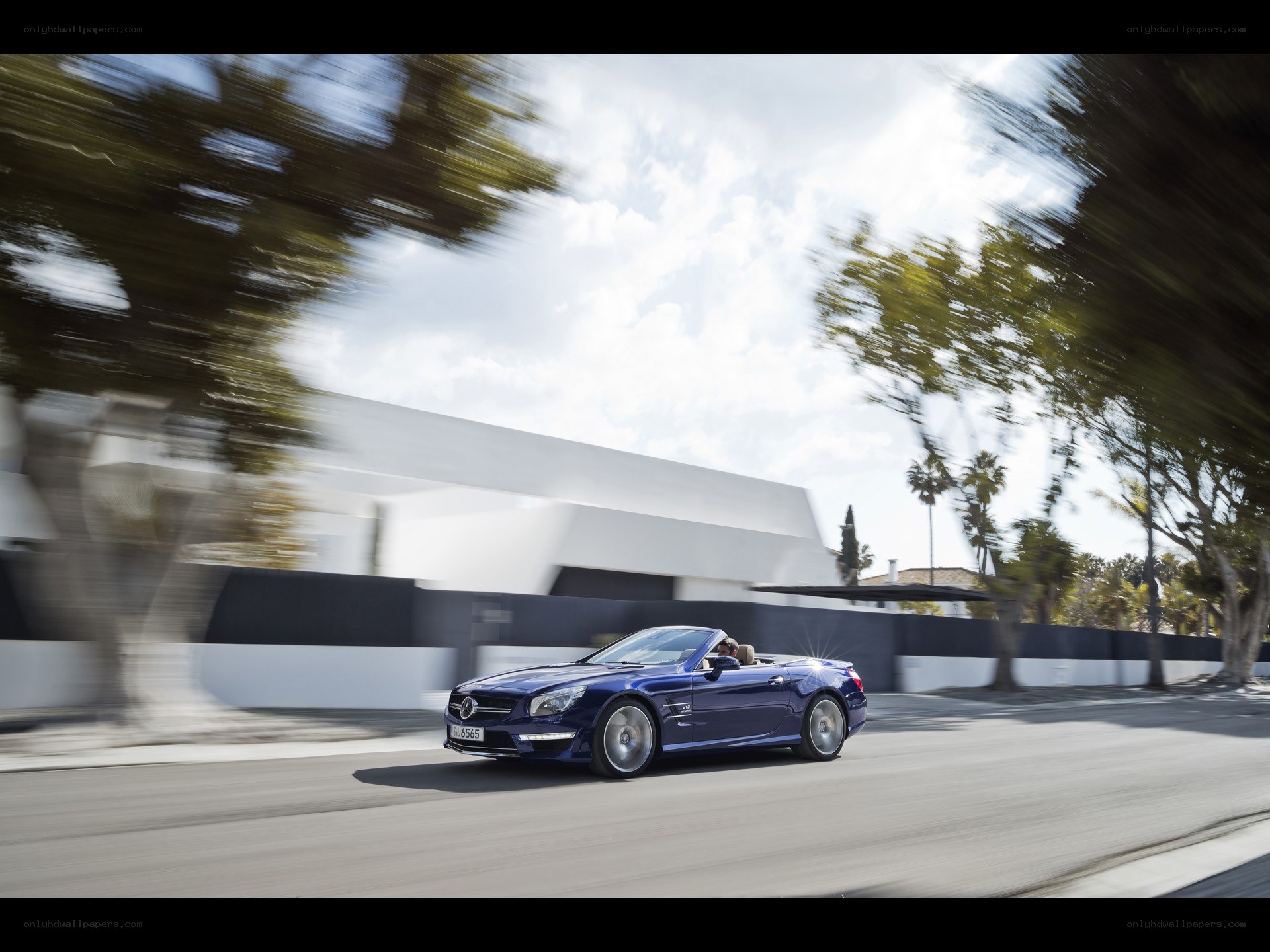 Blue convertible driving on road