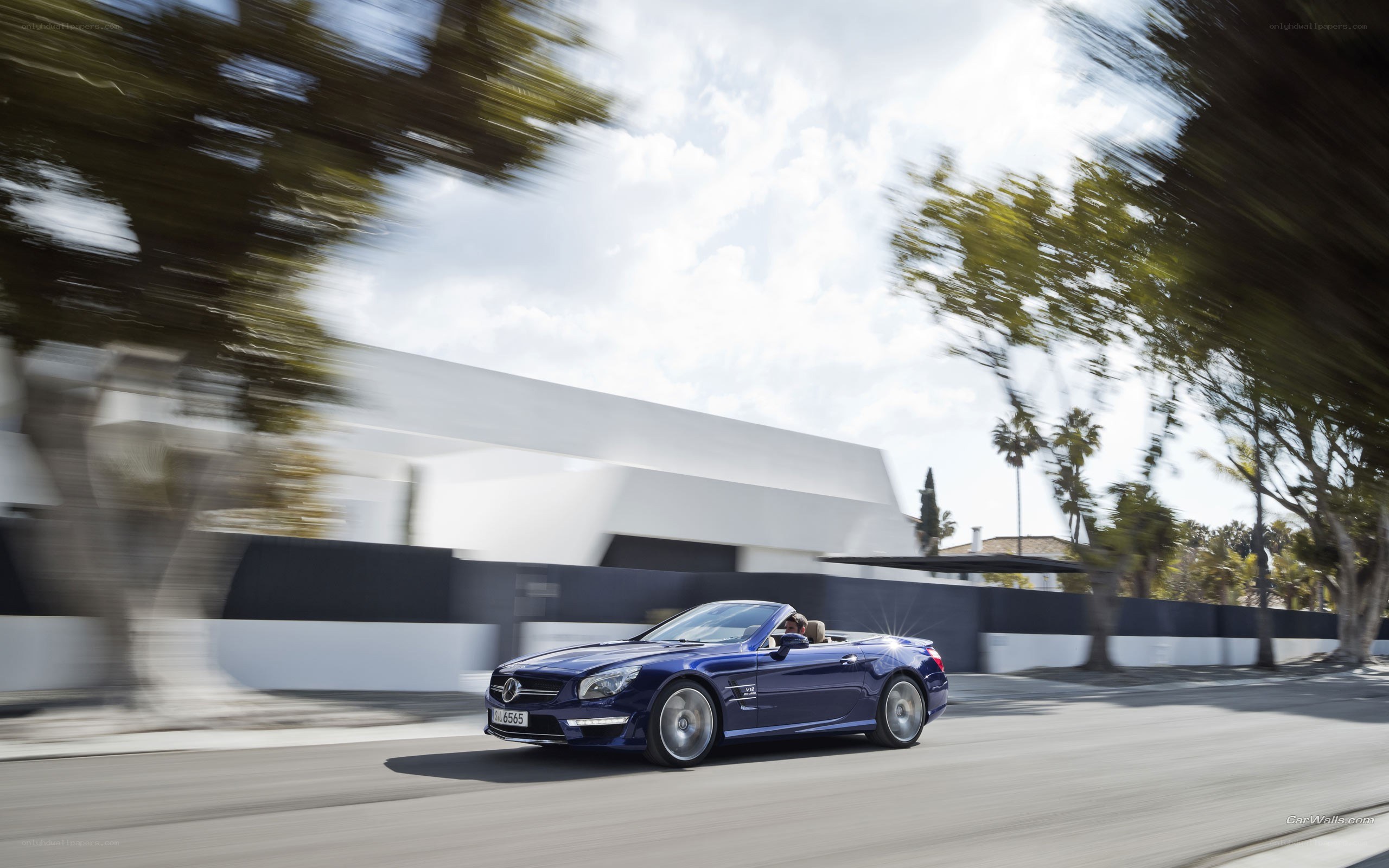 Blue convertible driving on road