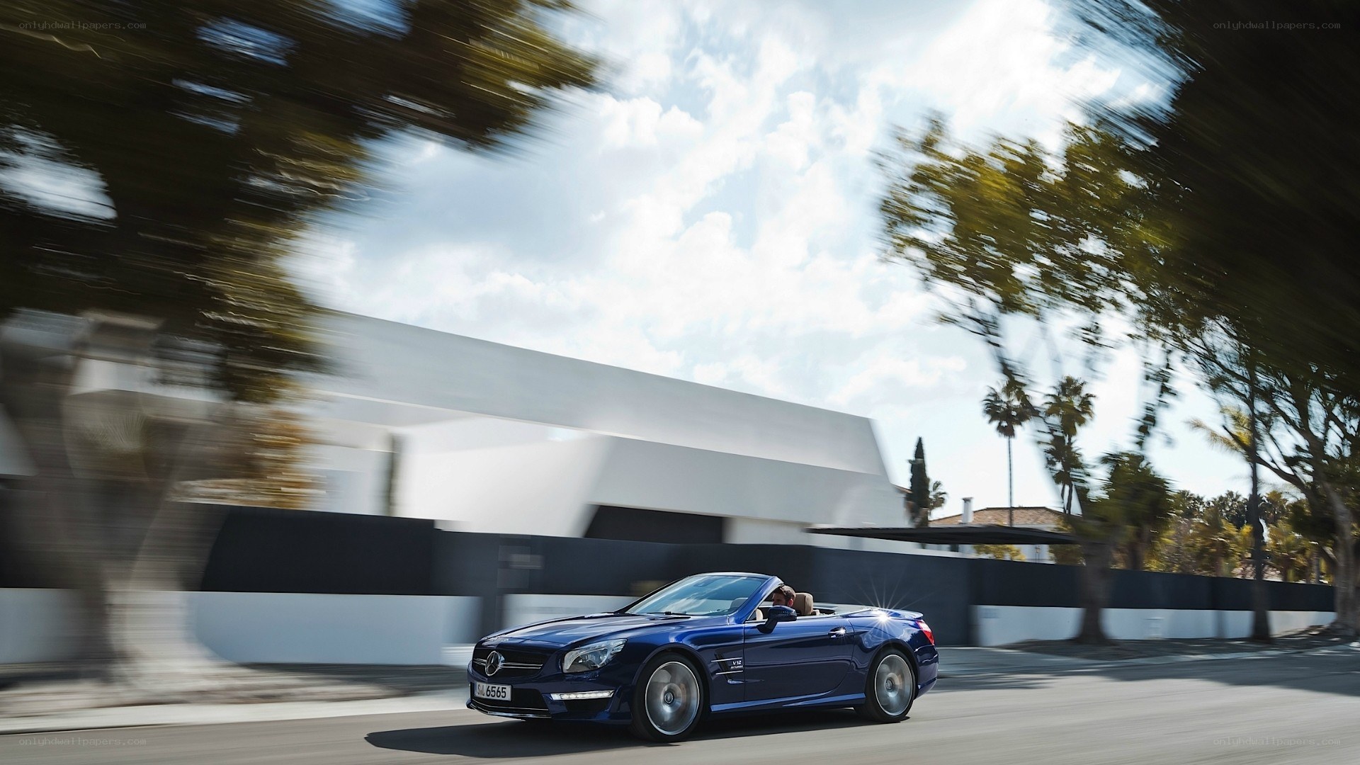 Blue convertible driving on road