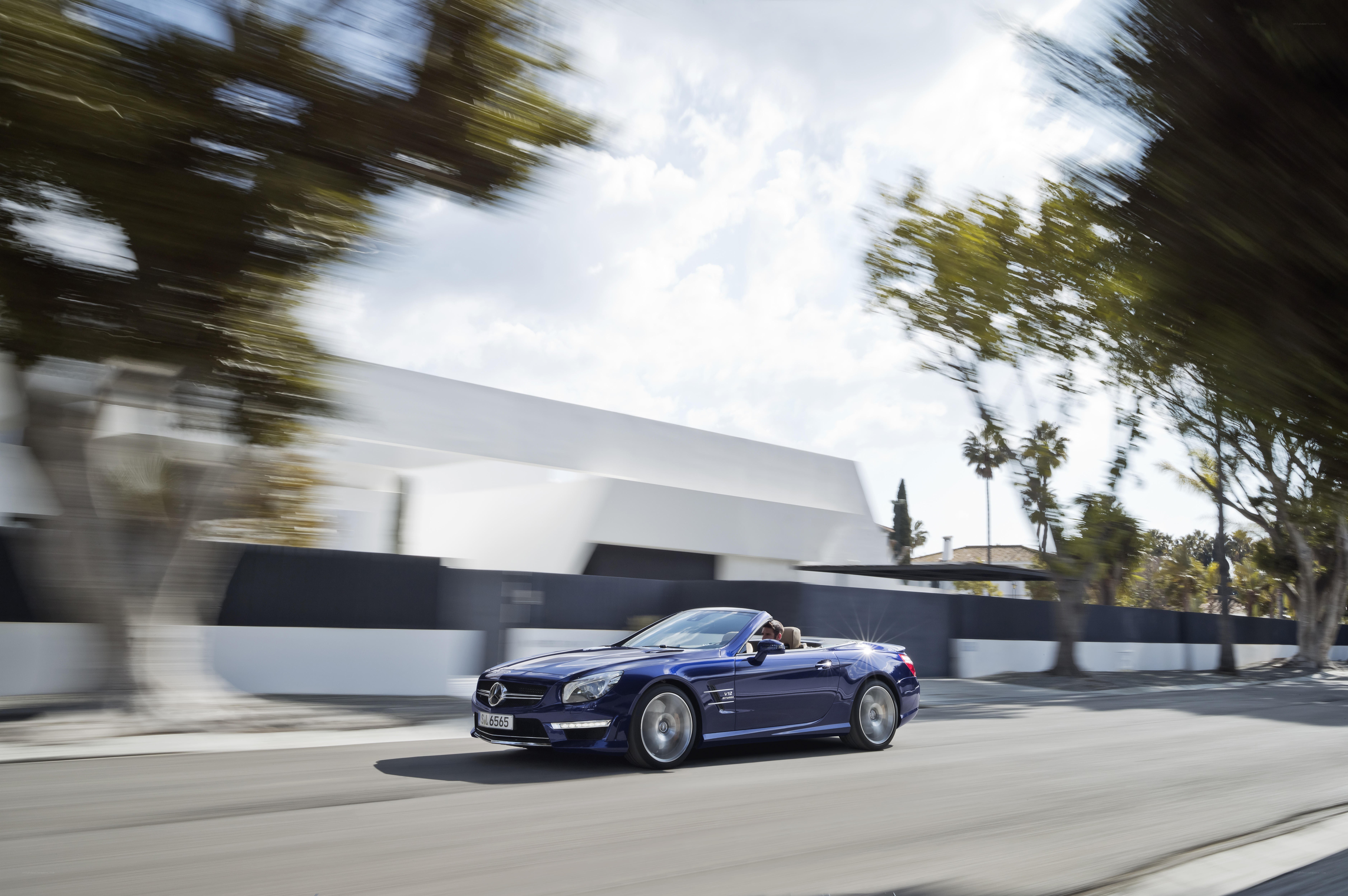 Blue convertible driving on road