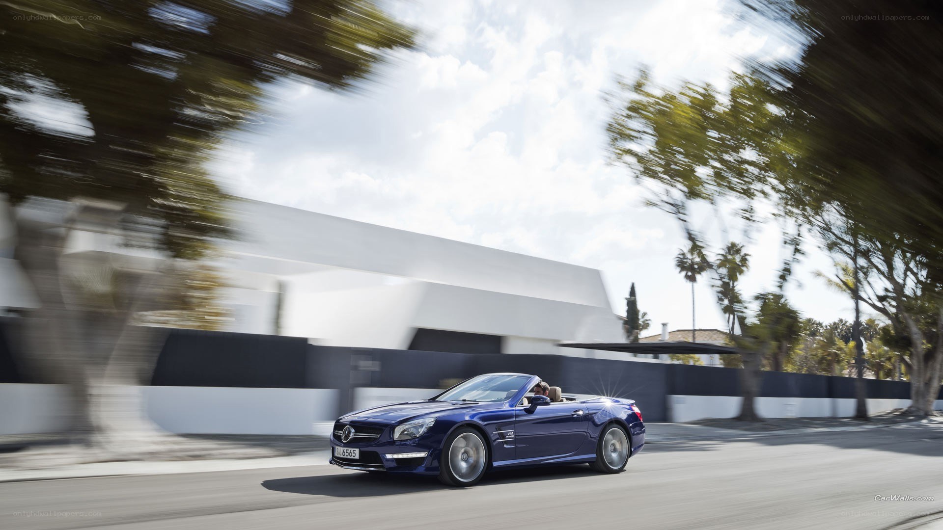 Blue convertible driving on road