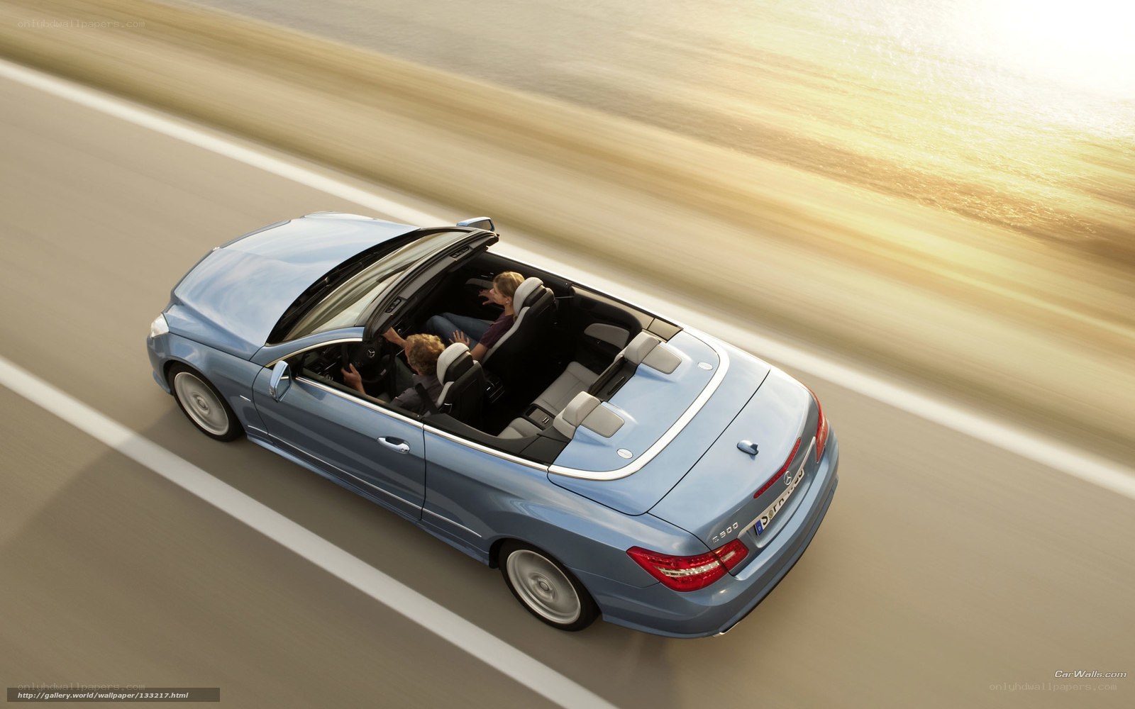 Blue convertible driving on road