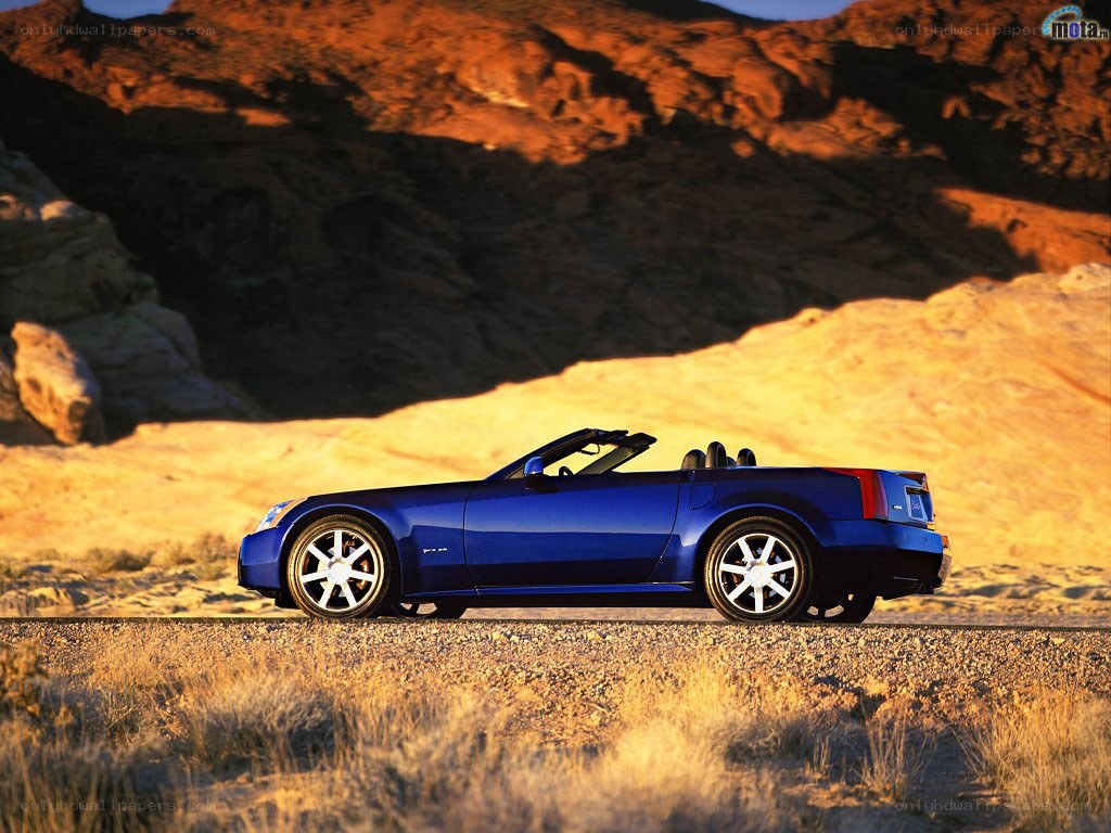 Blue convertible in desert landscape