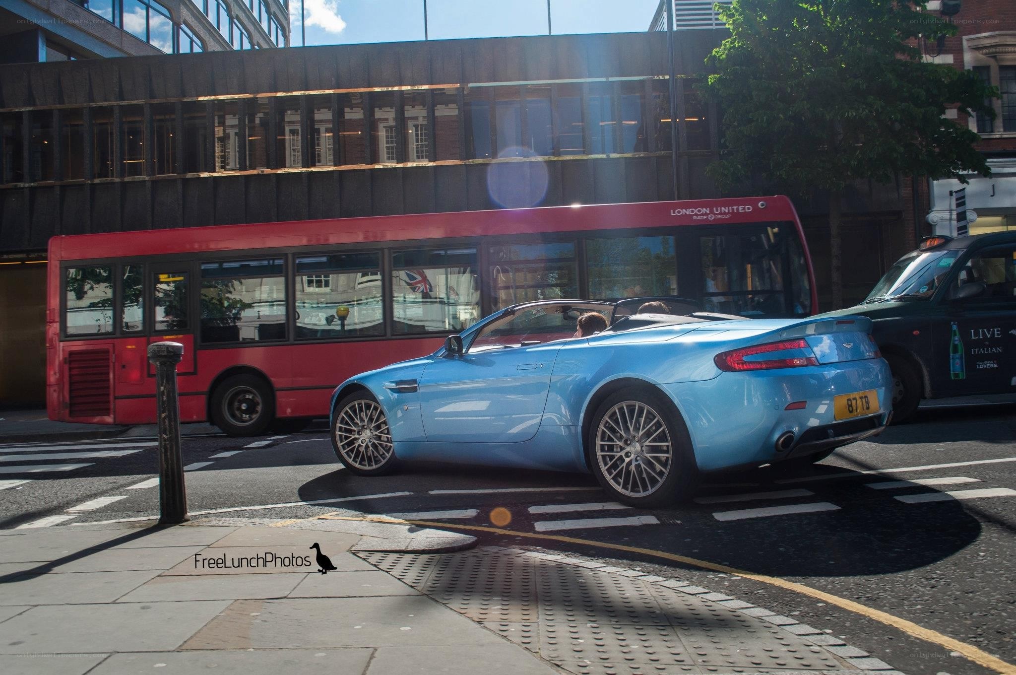 Blue convertible on city street