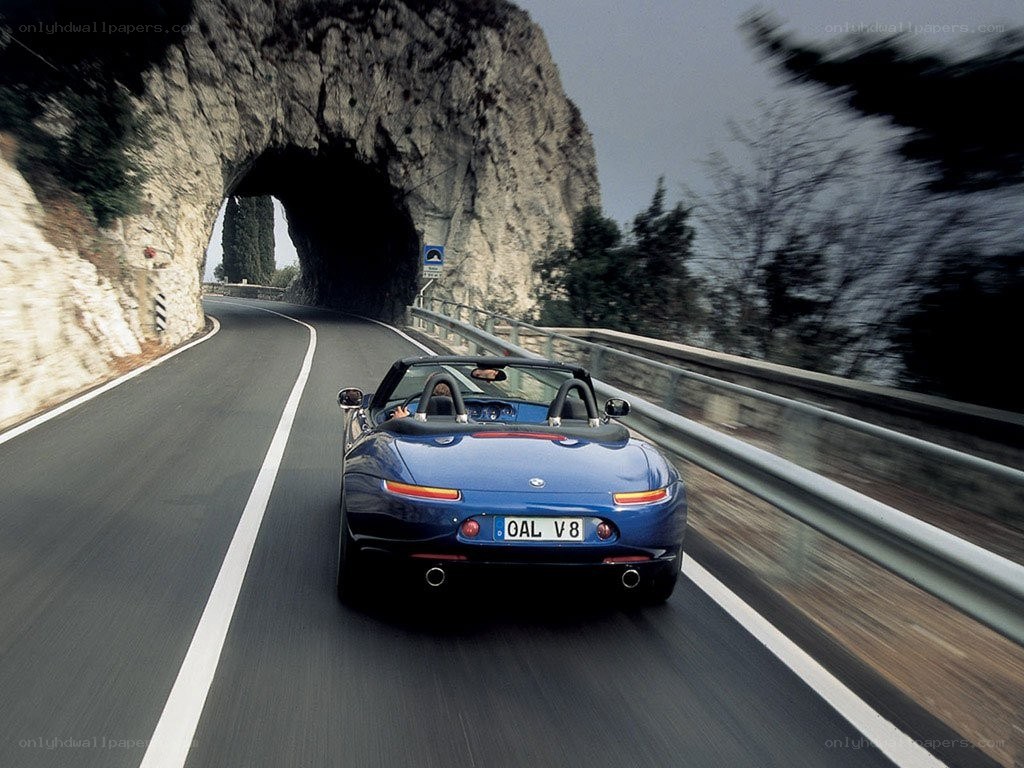 Blue convertible on coastal road
