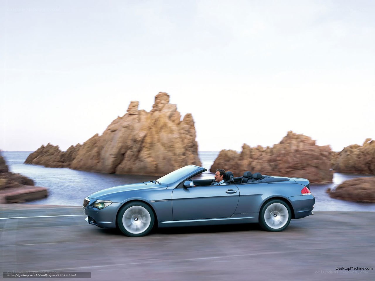 Blue convertible on coastal road