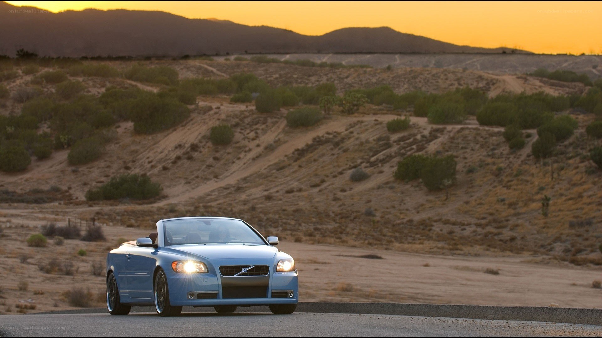 Blue convertible on desert road