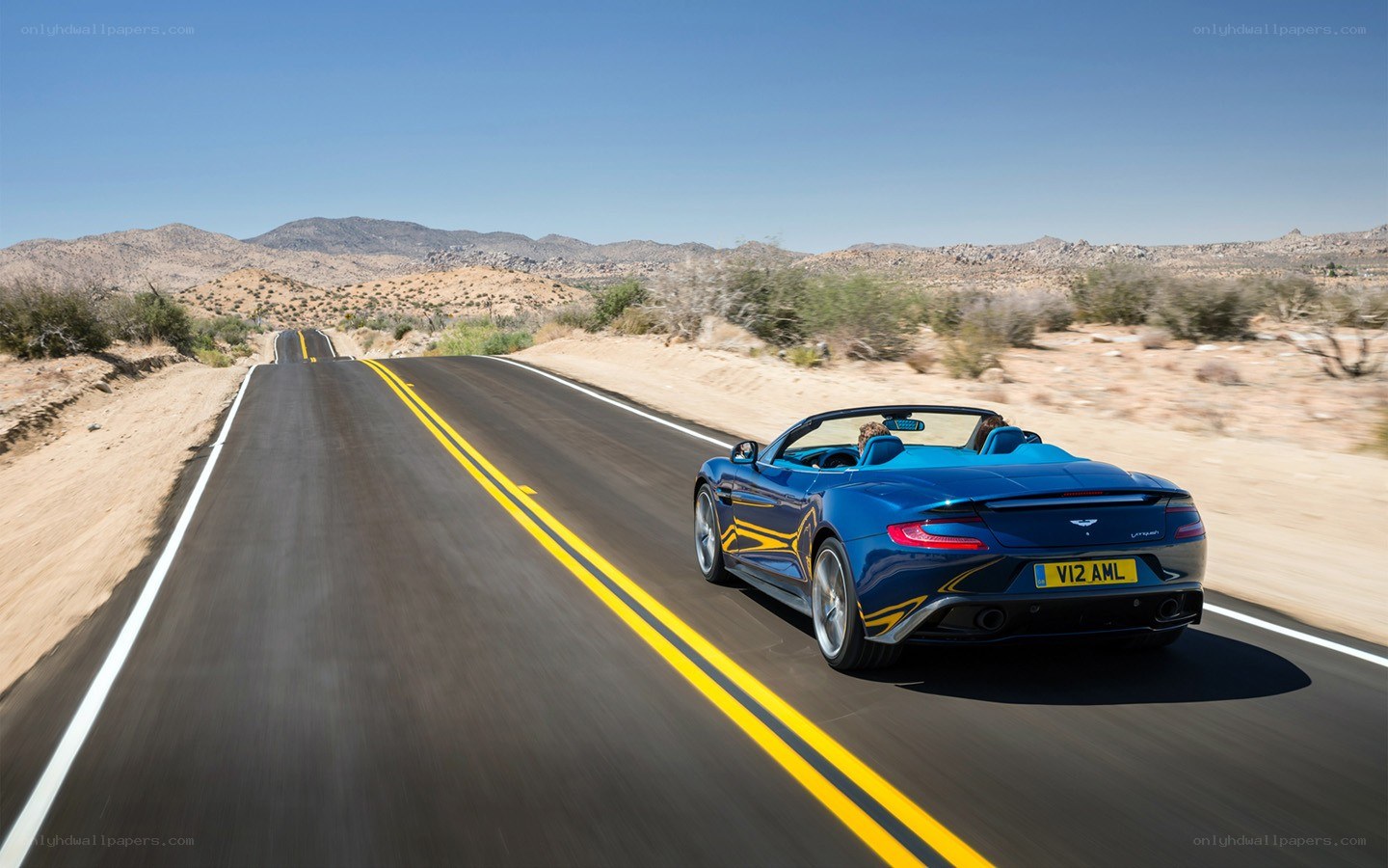 Blue convertible on desert road