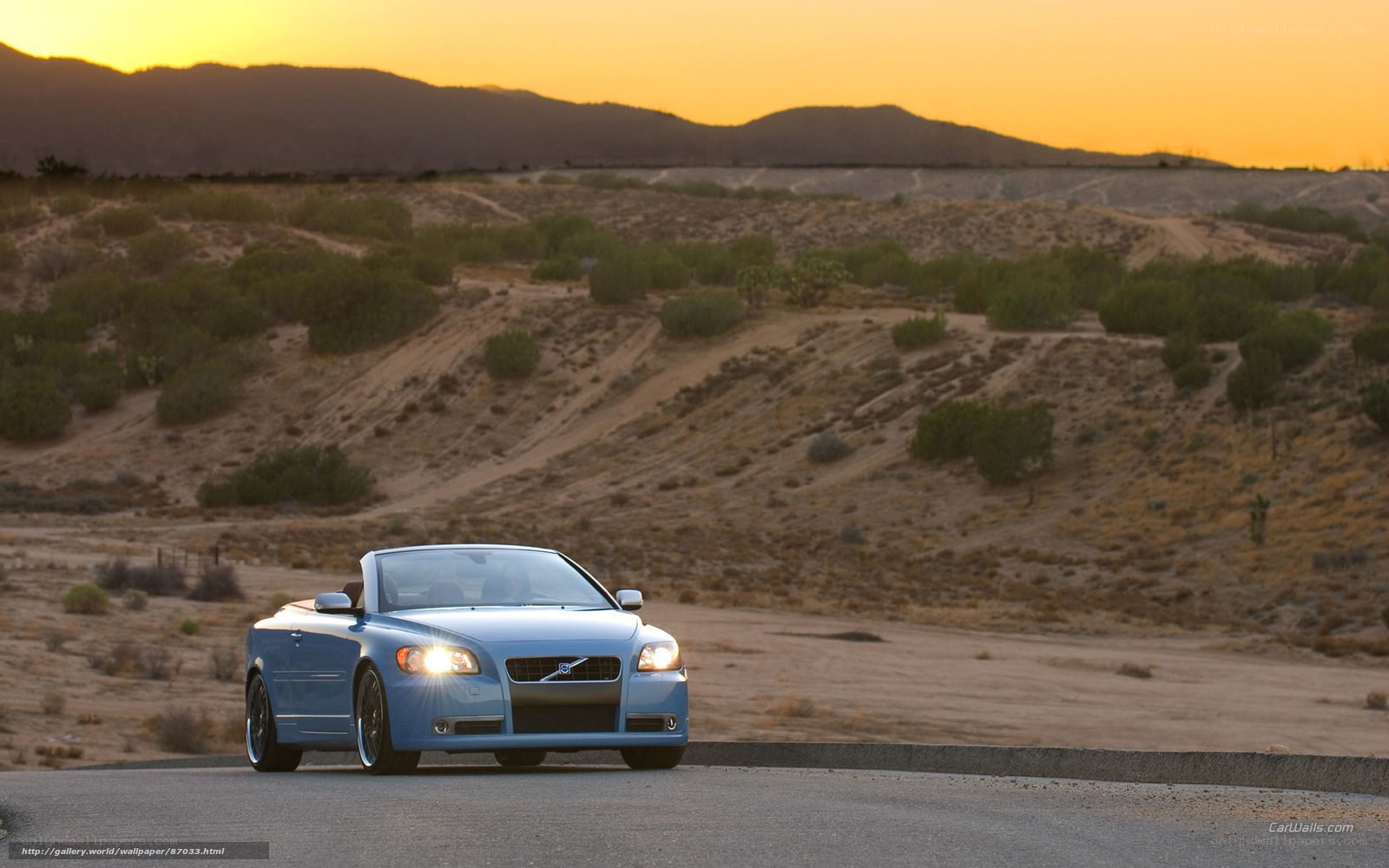 Blue convertible on desert road