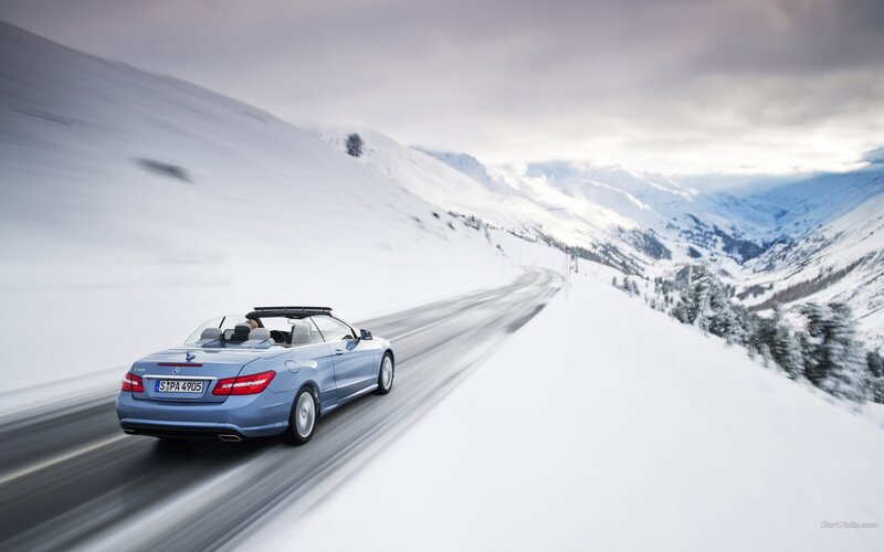 Blue convertible on snowy road