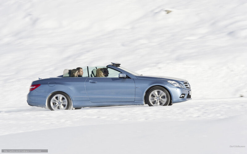 Blue convertible on snowy road