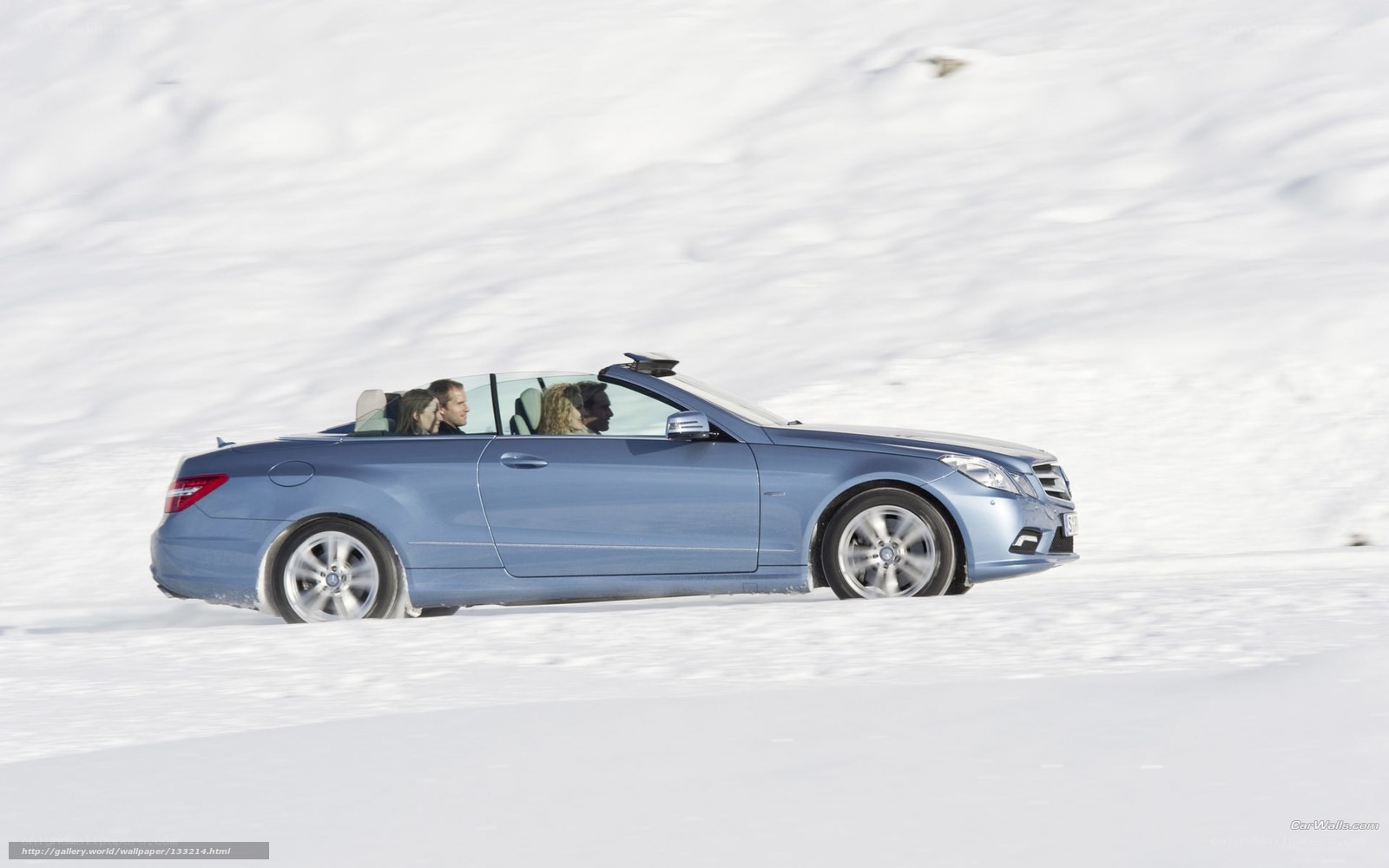 Blue convertible on snowy road