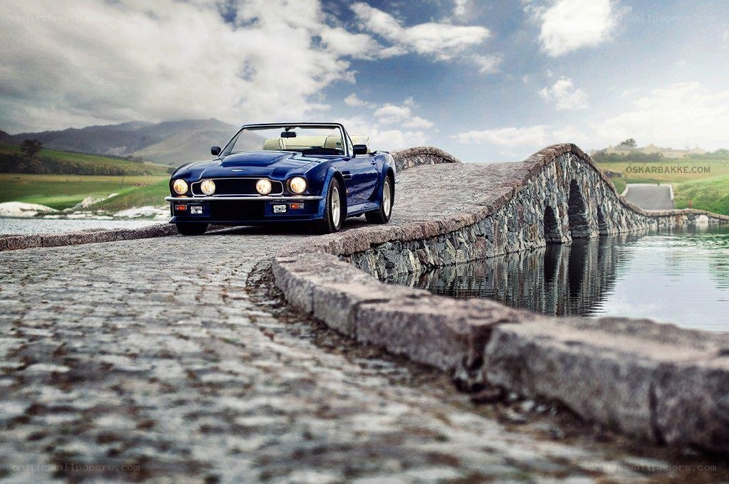 Blue convertible on stone bridge