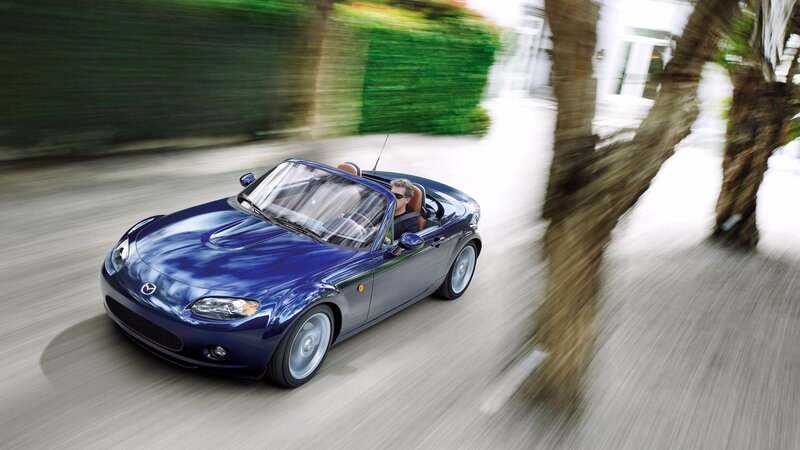 Blue convertible sports car in motion