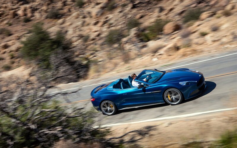 Blue convertible sports car on road