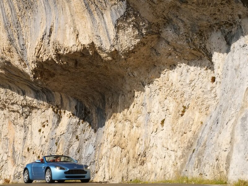 Blue convertible under rock arch