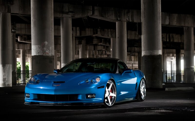 Blue Corvette Car — Dramatic, Night, Photograph, Concrete Pillars, Overpass
