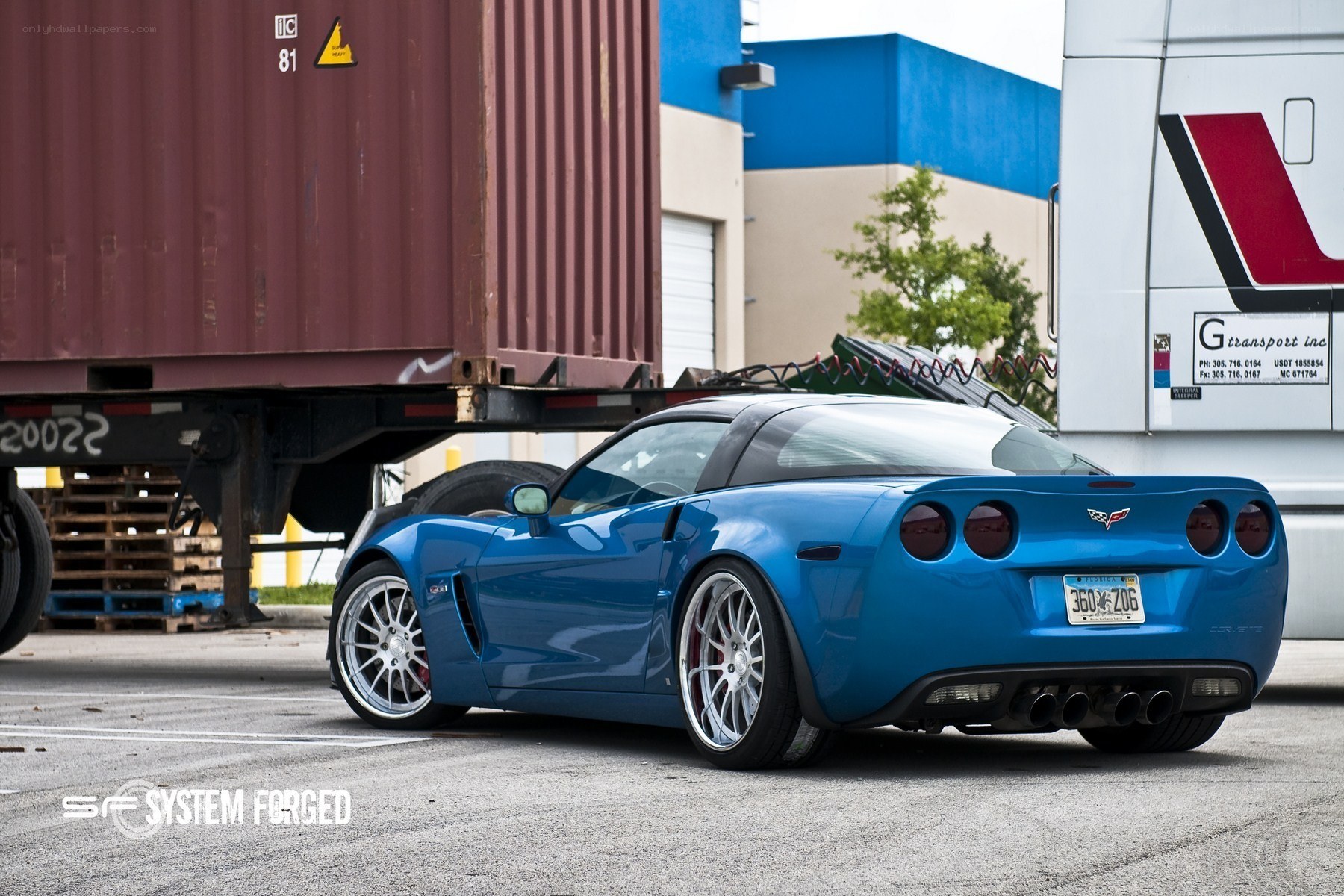 Blue Corvette in a shipping yard