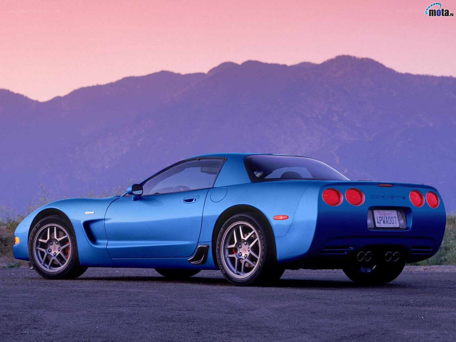 Blue Corvette on a mountain road