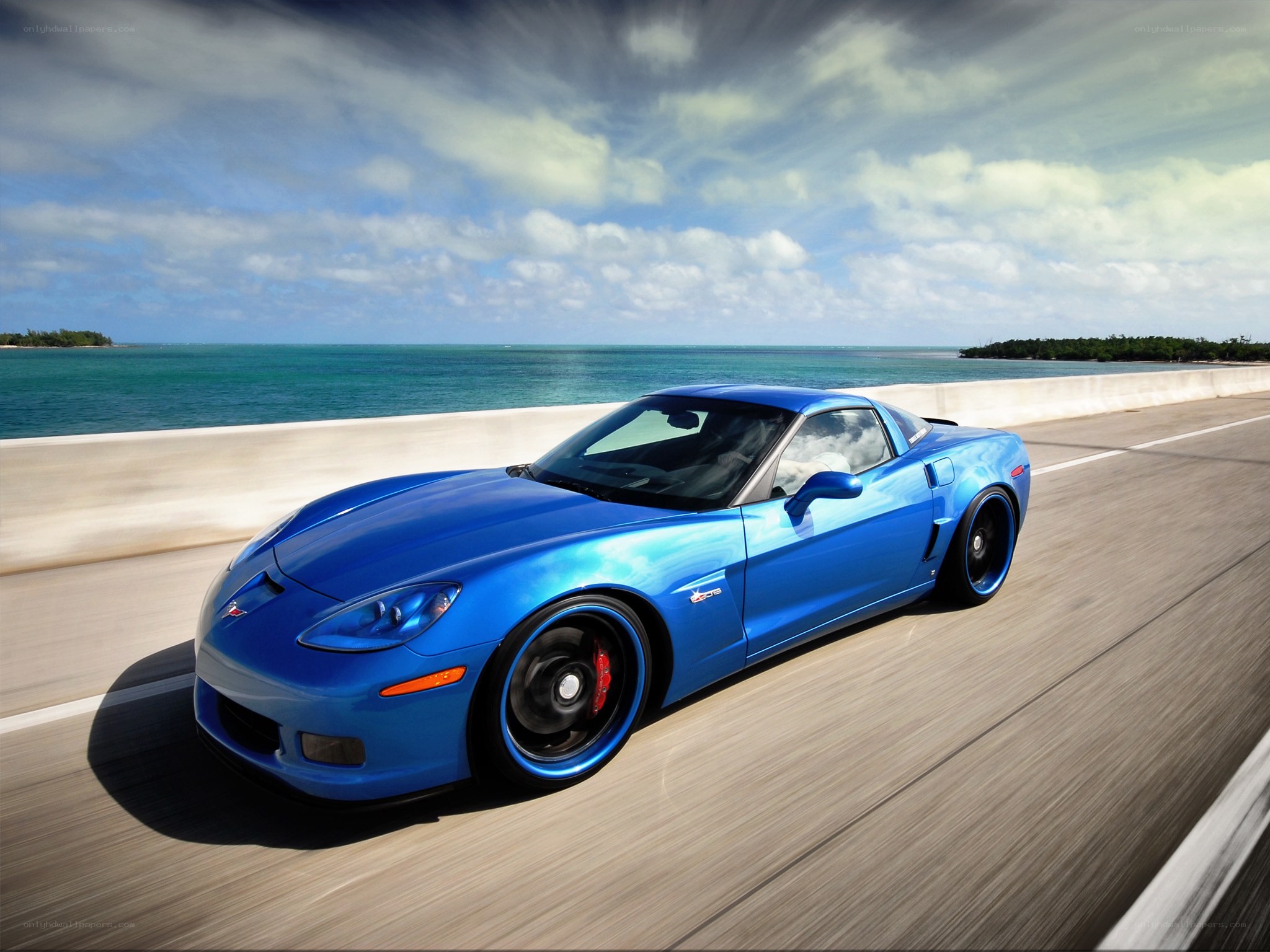 Blue Corvette on coastal road