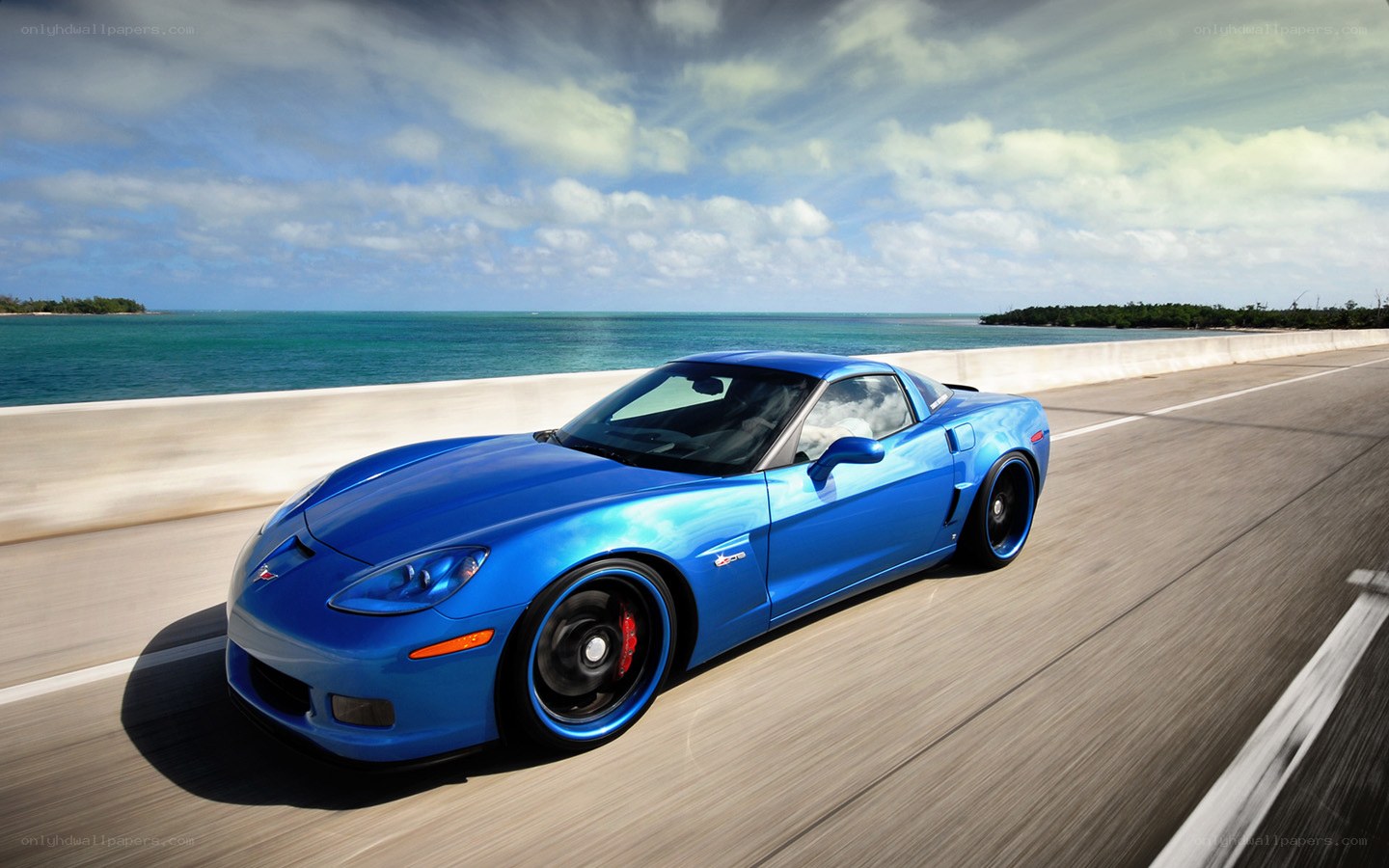 Blue Corvette on coastal road