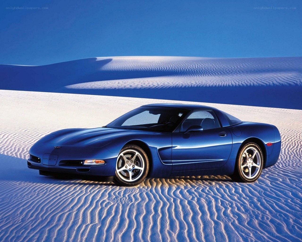Blue Corvette on sand dunes