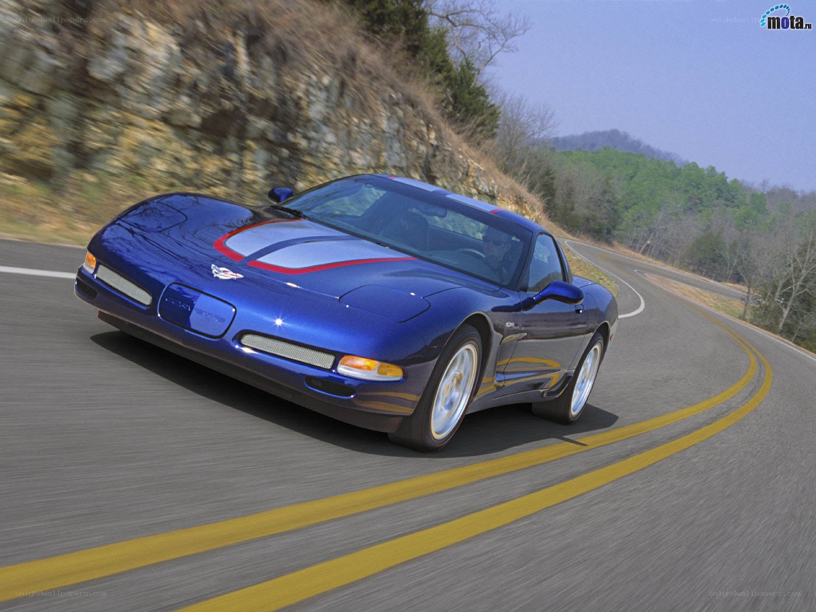 blue corvette on winding road