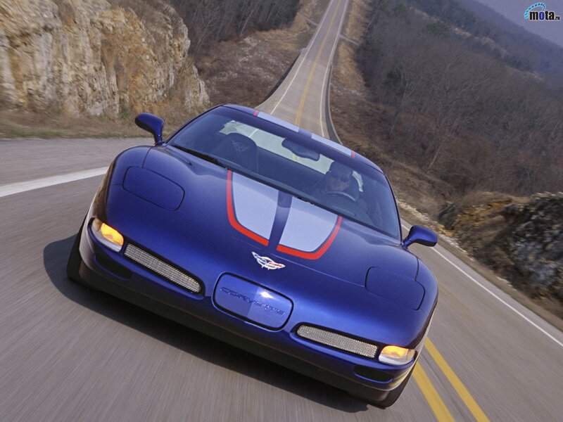 blue corvette on winding road