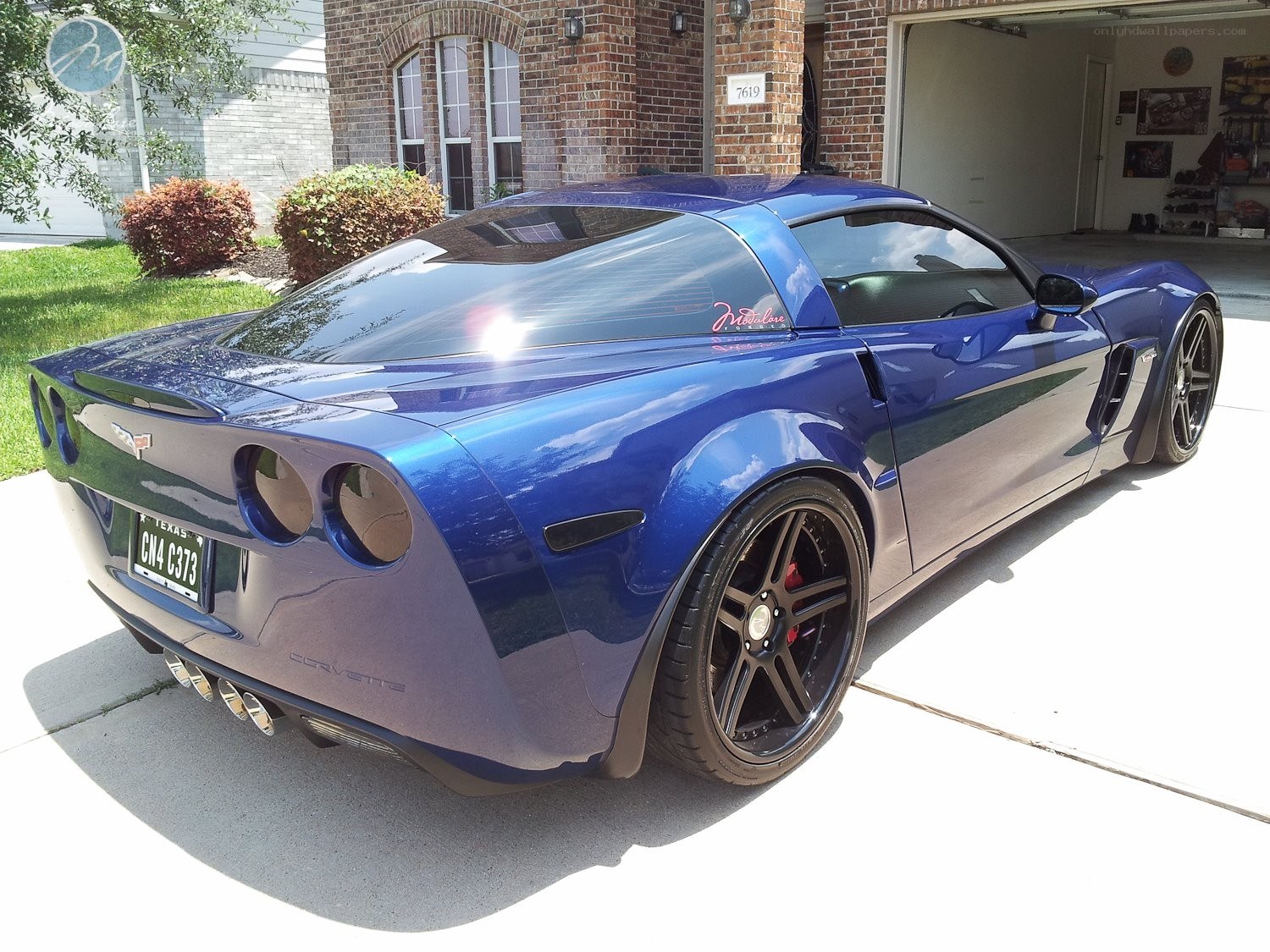 Blue Corvette parked in driveway