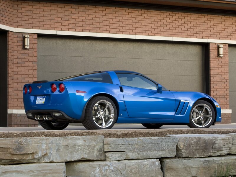 Blue Corvette parked outside garage